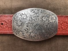 "90s southwestern embossed leather belt with pewter tone engraved belt buckle.  c. 1994. Size XL. Fits a waist range of approx 40\"-44\" on 5 notches.  Recommended for 40\"-42\". About 1.5\" wide Buckle 2 3/8\"x 3.5\"" Silver Engraved Western Belt, Western Silver Engraved Belts, Silver Hand Tooled Adjustable Belt Buckles, Adjustable Silver Hand-tooled Belt Buckles, Vintage Engraved Belt Buckles For Rodeo, Western Style Engraved Adjustable Belts, Engraved Adjustable Western Belt Buckles, Western Engraved Adjustable Belt, Western Style Adjustable Engraved Belts