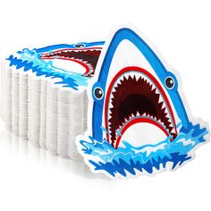 an image of a shark with teeth in the water on white paper napkins that are cut out to look like it's coming out of the ocean