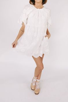 This white embroidered floral mini dress is the epitome of romantic elegance. Featuring a delicate scallop hemline and ruffle lace details, it is the perfect addition to any summer wardrobe. Enhance your feminine charm and steal hearts wherever you go with this beautiful dress. Details Round neckline Keyhole closure Ruffle lace details Embroidered fabricaiton Scallop hemline Lined Pockets Sizing Approximate measurements: SIZE LENGTH BUST WAIST Small 33” 36” 36” Medium 33” 38” 38” Large 34” 40” 40” Fabric has no stretch Model is 5’8” wearing small Material Self: 85% Tencel 15% NylonLining: 97% Polyester 3% Spandex Hand wash cold cold Do not bleachLay flat to dryFor best results dry clean Flowy Lace Dresses With Floral Embroidery, Flirty Spring Mini Dress With Scalloped Lace, Flirty Lace Mini Dress For Spring, Feminine Lace Trim Mini Dress, Summer Scalloped Lace Mini Dress, Flirty Lace Dress For Garden Party, Daywear Mini Dress With Scalloped Lace, Floral Embroidered Lace Mini Dress, Lace Mini Dress With Floral Embroidery For Garden Party