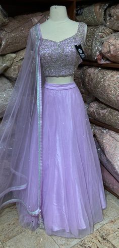 Lilac purple embroidered lehenga features in stone work. Completed look with cut dana, sequence and stone embellishments blouse and net dupatta. Fabric: Net Occasion: Wedding Ceremony or Reception. WASH CARE INSTRUCTIONS - Please Dry clean only when it is applicable. Slight color variation is possible due to digital photography. This outfit can be customized in multiple colors and specific to client measurements. 120 days of production time is required and are for bulk orders only!Order are proc Lavender Zari Work Sets For Wedding, Lavender Zari Work Wedding Sets, Lavender Wedding Sets With Zari Work, Lavender Wedding Set With Zari Work, Lavender Lehenga With Zari Work For Wedding, Lavender Wedding Set With Sheer Dupatta, Lavender Sharara With Sheer Dupatta For Wedding, Lavender Wedding Sharara With Sheer Dupatta, Wedding Lavender Sharara With Sheer Dupatta