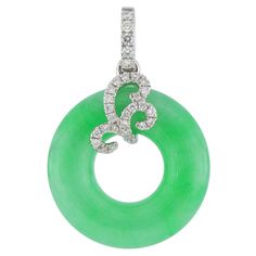 A translucent bright green natural jadeite pendant in a perfect round donut shape, decorated with round brilliant-cut diamonds, weighing 0.178 carats in total, mounted in 18 karat white gold. This is a very elegent piece of jewellery with Oriental essence and stylish design. The company was founded one and a half centuries ago in Macau. The brand is renowned for its high jewellery collections with fabulous designs. Our designs reflect the cultural and aesthetic value of its origin – Macau, where East meets West, with the inspiration from the beauty of oriental and Roman art. The finest hand selected precious stones inspire our designers’ creation, which are turned into exquisite jewellery with exceptional flair, in the hands of our expert craftsmen. Jade Jewellery, High Jewellery, Donut Shape, Roman Art, Jade Jewelry, Jade Pendant, Exquisite Jewelry, High Jewelry, Macau