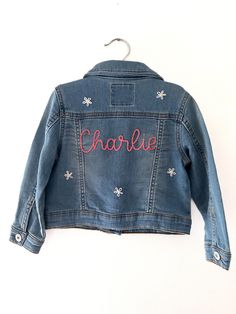 A custom baby name denim jacket is an adorable addition to your child's wardrobe, a great way to announce your baby's name to the world, and would make an amazing baby shower present or child's birthday gift. Allow your son or daughter to celebrate their name through flaunting it on their attire. When your little guy or gal grows out of their jean jacket, it will be a special keepsake to cherish for years to come.  All custom pieces are hand-embroidered with the name of your choice after your purchase is made.  To complete your order, please leave your baby's name and your string color in the personalization box (any string color not specified will be stitched in white) and select your coat size and color from the drop-down menu. If you order the design with flowers, flowers will be white Customizable Blue Denim Jacket, Customizable Denim Jacket For Spring, Spring Customizable Denim Jacket, Cute Medium Wash Cotton Denim Jacket, Customizable Blue Denim Jacket For Spring, Customizable Cute Cotton Outerwear, Cute Customizable Cotton Outerwear, Customizable Long Sleeve Denim Jacket, Cute Medium Wash Denim Jacket