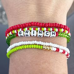 Show a little Christmas spirit with this fun Grinch inspired bracelet set. Perfect for gift giving for those that love the holidays! Secret Santa gift, holiday housewarming or something to enjoy for yourself.  You will receive 5 bracelets in this set. Each piece is handmade with: - High Quality Glass Seed Beads - White/Black Acrylic Cube Letter Beads - Stretch Cord: High-quality cord with reinforced knots Easily layer with other Luna by Rachel bracelets for a stunning stack! My pieces are made sturdy, but as with all jewelry, they are also delicate and should be treated with care. Be sure to check out other designs in my shop at http://etsy.com/shop/lunabyrachel  Thank you for shopping Luna by Rachel ~ Unique Jewelry for Unique Individuals Make Clay Beads, Tiny Bead Bracelet, Small Bead Bracelet, Braided Bracelet Diy, Jewelry Making Business, Stack Bracelets, Trending Bracelets, Word Bracelet, Clay Bracelet