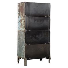 an old metal storage unit with four bins on it's sides and rusted paint