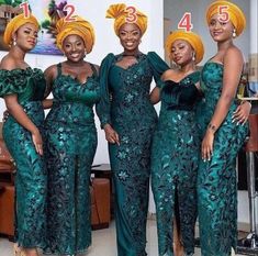 three women in green dresses standing next to each other and one is wearing an orange turban