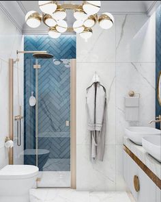 a white bathroom with blue and gold accents on the shower wall, toilet and sink