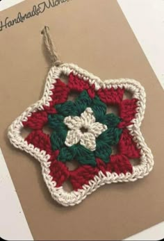 a crocheted ornament is hanging on a card