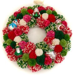 a christmas wreath with pom - poms and ornaments