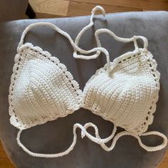 two crocheted bras sitting on top of a chair