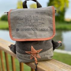 The General's Backpack is made of repurposed Military Canvas constructed into this perfectly styled sturdy and durable backpack with Military Print Markings on the outer Flap. There is space for everything you need in this Military Fashioned Upcycled Backpack, which is perfect for a Student, Travel, or Everyday running. Please note, there is no longer a key added to the front of the bag. Bag Details* 12.5" x 13" x 3.75" - Size Matters! Please check out these dims! * Snap Front Closure* Fully lin Vintage Canvas Satchel Backpack, Vintage Canvas Backpack With Adjustable Strap, Vintage Standard Backpack For Back To School, Vintage Backpack For Back To School, Vintage Canvas Backpack For Everyday Use, Vintage Backpack With Canvas Lining, School Backpack In Waxed Canvas, Vintage Waxed Canvas Backpack For Daily Use, Outdoor Satchel Backpack For Back To School