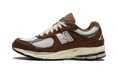 The New Balance 2002R “Brown/Beige” is a versatile, earth tone colorway of the retro running and lifestyle shoe.  The New Balance 2002R was introduced in 2010 as a running shoe before returning as a casual lifestyle shoe in the 2020s.  The “Brown/Beige” features a cream mesh base with brown suede overlays and grey leather overlays.  A grey “N” logo appears on either side of the shoe.  Silver “2002R” branding is found on the lateral heel.  The shoe is finished off with a cream foam midsole that g Brown Running Shoes, New Balance 2002r Brown, 2002r New Balance, Sneaker Displays, New Balance 2002r, N Logo, Work Fits, Casual Lifestyle, Outfit Plan