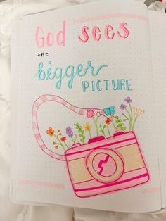 an open notebook with the words god sees, he's bigger picture on it