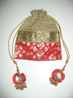 Gorgeous Potli bag.  Red and gold silk patterned bottom, crocheted top, drawstring closure.  Decorated with sequins and beads and tassels.  Measures 9.5" high and 7.5" across.  I am happy to answer any questions.  Returns on unused items only. Potli Bag, Potli Bags, Gold Silk, Purse Bag, Red And Gold, Clutch Purse, Red Gold, Crochet Top, Crochet Earrings