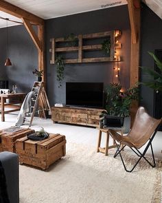 a living room filled with furniture and a flat screen tv on top of a wooden stand