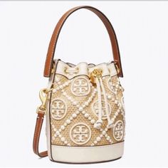 Description Brand: Tory Burch Product name: T Monogram Straw Mini Bucket Bag ToT Monogram Straw Mini Bucket Bag leather decoration/bottom Optional: Adjustable shoulder strap Lining: herringbone Height: 18cm/Width: 15cm/Depth: 12cm Strap drop: 54cm/Handle drop: 9cm Shipping   USA Asia,N.America Europe Australia South America Express Free Free Free ?20 Handling time: about 5to10 days after payment. Time from shipment to arrival: ?USA: Fedex(with tracking) about 4-5 days ?Europe: Fedex(with tracking) Approximately one week We will make a secure transaction with a tracking number. ?Other countries: Basically, Fedex. International Buyers - Please Note: For second-hand items, the condition of the scratches may differ slightly from the image depending on the lighting conditions and shooting condi Luxury Tan Bucket Bag With Handles, Beige Monogram Canvas Bag With Gold-tone Hardware, Designer Beige Satchel Bucket Bag, Cream Monogram Canvas Top Handle Bag, White Monogram Canvas Bag With Adjustable Strap, Luxury Beige Pouch Bucket Bag, Designer Cream Bucket Bag With Gold-tone Hardware, Designer Cream Bucket Bag With Detachable Handle, Luxury Cream Crossbody Bucket Bag