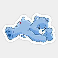 a blue teddy bear laying on its back with a heart in it's paws