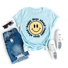 Looking for a cute versatile top to wear this summer? Make sure to grab one of our Happy Days Ahead Smiley Face tees! This soft and comfortable graphic tee is the perfect top for any outfit. It can be paired with biker shorts, jeans, or even a simple skirt/dress! This tee is true-to-size, so be sure to order your regular t-shirt size! If you are looking for a more oversized look, make sure to size up! Smiley Face Tee, Mauve Blush, Baby Boy Toys, Happy Days, Cable Knit Cardigan, Floral Jumpsuit, Boutique Brands, Smiley Face, Ice Blue