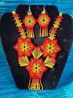 Gorgeous Handcrafted Huichol Necklace Set | 3 Flower That Forms a Heart| Necklace and Earrings|    You will be amazed by the beautiful bead work of this handcrafted necklaces, all with beautiful unique bright colors and patterns.  They are handmade by very talented Mexican Artisans in Chiapas, Mexico. They represent their beautiful culture and hardwork.  wear it with pride! *This necklace has double face, can be weared both sides *Set includes Necklace and Earrings Huichol Necklace, Beautiful Culture, Necklace And Earrings Set, Handcrafted Necklace, Necklace And Earrings, Hama Beads, Double Face, Earrings Set, Heart Necklace