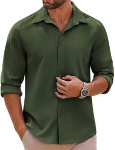 a man wearing a green shirt and khaki pants with his hands in his pockets