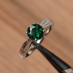 It is a lab emerald ring. The main stone is 7mm*7mm round cut, weight about 1.3 carats. The basic metal is sterling silver and plated with rhodium. To change the metal to a solid gold (white/rose) or platinum is also available, please ask for a quotation if you want. You can also go to my shop Home for more elegant rings: https://www.etsy.com/shop/godjewelry?ref=hdr_shop_menu More emerald rings: https://www.etsy.com/shop/godjewelry?ref=seller-platform-mcnav&section_id=20709240 Customization Elegant Rings, Pink Morganite Engagement Ring, Green Gemstone Ring, Emerald Rings, Cushion Cut Ring, Morganite Engagement Ring, Elegant Ring, Green Gemstones, Anniversary Ring