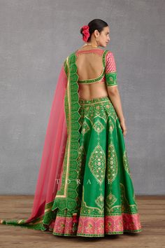 Editor's Note Featuring a persian blue bhagalpuri printed lehenga set in raw silk having heavy tassel strings Color: Green pink Fabric: Heavy raw silk, silk organza Components: Lehenga, blouse and dupatta Fit: Fitted at bust Occasion: Haldi mehndi and Wedding Guest Care: Dry Clean Only About the Designer Torani by Karan Torani stands handcrafted luxury inspired by the myriad tales of Indian mythology. Torani is a potpourri of all things nostalgic that binds you with a memory long forgotten. The Kalidar Lehenga, Lengha Blouse Designs, Gota Embroidery, Leaf Sleeve, Pink Dupatta, Lehenga Design, Printed Lehenga, Indian Bride Outfits, Green Lehenga