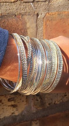 These are unqiue  silver  Large and chunky size  boho style They are very lightweight  The circumference is 2 3/4 wide on the solid bangles  20 total bangles  These will fit most large wrist size They look great layered or worn individually  Great addition to any unique wardrobe Bohemian Silver Cuff Bracelet For Parties, Silver Bohemian Cuff Bracelet For Party, Silver Stackable Metal Bangle, Silver Metal Bangle For Party, Silver Bling Cuff Bangle Bracelet, Bohemian Silver Stackable Cuff Bracelet, Silver Stackable Bohemian Cuff Bracelet, Bohemian Silver Metal Bangle, Silver Stackable Bangle Cuff Bracelet