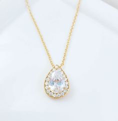 "This cubic zirconia teardrop necklace is made with a 13x16mm teardrop pendant which hangs on an adjustable cable chain with a lobster clasp, which can be worn from 18 to 19-1/2 inches. This sparkly necklace is perfect for weddings, proms or any pretty occasion. Thank you for looking.   NOTE: Gemsicles' gold-filled, rose/gold-plated, antiqued, silver and rhodium jewelry is cadmium-free, lead-free and nickel-free. Also, our plated jewelry is dipped in a special coating to help prevent fading. :) Gold Cubic Zirconia Teardrop Bridal Necklace, Classic Teardrop Solitaire Necklace For Wedding, Pear Shaped Brilliant Cut Solitaire Necklace For Wedding, Pear-shaped Brilliant Cut Solitaire Necklace For Wedding, Gold Teardrop Solitaire Necklace For Wedding, Gold Solitaire Necklace With Teardrop Pendant For Wedding, Teardrop Brilliant Cut Necklace For Wedding, Pear-shaped Cubic Zirconia Bridal Necklace Gift, Teardrop Brilliant Cut Wedding Necklaces