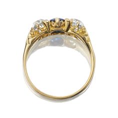 an antique diamond and gold ring, with three diamonds on each side in the center