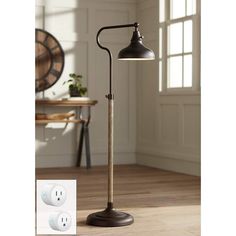 a floor lamp with an outlet plugged in to it and the light is on