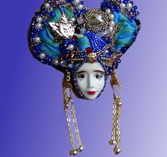 a woman's head is adorned with beads and pearls, as well as a mask