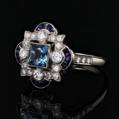 For Sale on 1stDibs - Ring in 18 karat white gold. This Art Deco-style ring is set with a square aquamarine in millegrain closed setting in the center of an openwork design Luxury White Gold Ring With Aquamarine, Luxury White Gold Aquamarine Ring, Blue Square-cut Platinum Ring, Blue Platinum Rings With Square Cut, Blue Square Cut Platinum Ring, Blue Platinum Square Cut Ring, Fine Jewelry White Gold Square Cut Sapphire Ring, Luxury Square Cut Sapphire Ring, White Gold Square Cut Sapphire Ring