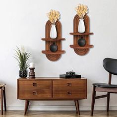 two wooden shelves with vases on top of them