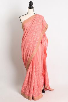 Get ready to turn heads at any event with this stunning Partywear Georgette Chikankari Saree in Peach. The saree features intricate machine work Chikankari machine embroidery in a beautiful peach color, making it the perfect statement piece for any party or special occasion. The golden embroidery border adds a touch of elegance and sophistication to the saree, making it stand out from the rest. Made from high-quality georgette fabric, this saree is comfortable to wear and drapes beautifully, flattering any body type. Pair it with some statement jewelry and a stylish blouse to complete the look and make a lasting impression. Color : Peach and Gold.    Blouse Piece : Yes ( cut and separated from the saree ). Fall Pico : Yes.  Care: Dry-Clean Only. Traditional Peach Pre-draped Saree With Zari Work, Traditional Peach Pre-draped Saree For Festive Occasions, Traditional Orange Georgette Pre-draped Saree, Peach Traditional Wear With Resham Embroidery For Reception, Peach Semi-stitched Saree For Navratri, Traditional Pre-draped Peach Saree, Traditional Peach Pre-draped Saree With Dupatta, Fitted Orange Saree For Transitional Season, Unstitched Peach Lehenga For Festive Occasions