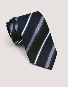 Add extra elegance to your look with this black-striped silk tie. Crafted from 100% silk, it drapes beautifully and offers a graceful wrap around the shirt collar. The classic black color is a sophisticated choice that works for any occasion. This versatile black tie pairs perfectly with a crisp plain formal shirt, or with a patterned shirt when you feel like having some fun. This tie shows off your good taste. 100% silk 100% polyester lining 8 cm width, 157 cm length Striped pattern Wardrobe hanger included Gift packaging available Elegant Edgy, Formal Shirt, Patterned Shirt, Tie Gifts, Men's Tie, Stripe Silk, Tie Accessories, Suit And Tie, Formal Shirts