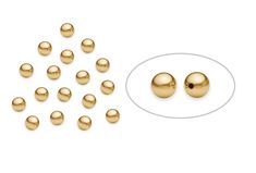 gold plated metal beads and a white background