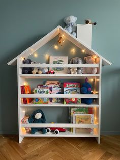 a book shelf filled with books and stuffed animals