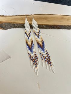 Very long narrow American style earrings. Made from Czech beads. Length 8 inches (20cm). Width 0.5inch(1.5cm) Hypoallergenic clasp. If you want these earrings in a different color, write to me and I will be happy to make them for you. White Long Drop Earrings With Dangling Beads, Long Drop Beaded Earrings, White Beaded Long Drop Earrings, White Long Drop Earrings With Colorful Beads, White Long Drop Earrings With Ear Wire, White Long Drop Ear Wire Jewelry, Long Beaded Earrings, Earrings Native American, Native American Earrings