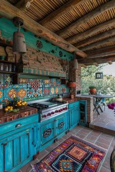 an outdoor kitchen with blue cabinets and tile backsplash