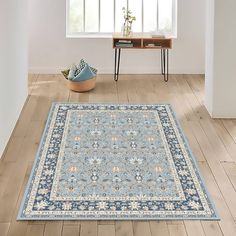 a blue area rug in an empty room