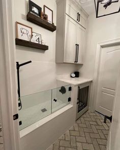 a bathroom with white walls and tile flooring