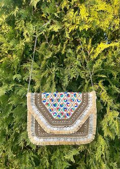 This is a beautiful handcrafted bohemian bag made with love. Get your boho vibe on with this chic and stylish bag. This Indian boho bag comes with intricate work and is the perfect festival bag. With its elegant and understated simplicity, this boho bag is eco friendly.  Decorated by hand, this boho bag is perfect for music festivals, vacations, or any adventure. Get your boho vibe on with this chic and stylish bag. Perfect as a handmade sustainable gift! Style tip : Throw in a pair of jeans with a summery top. The bag is so versatile that it goes with any outfit! IF THIS IS A GIFT, WE HAPPY TO ADD A HAND WRITTEN MESSAGE ON A CARD. PLEASE LEAVE A NOTE OR MESSAGE US. Dimensions - 30*23.5 CM Bohemian Clutch Bag With Tassels, Bohemian Tassel Clutch Bag, Bohemian Clutch Shoulder Bag With Tassels, Bohemian Tassel Clutch Shoulder Bag, Beige Rectangular Bag For Festivals, Festival Rectangular Bags With Multicolor Embroidery, Festive Beige Rectangular Shoulder Bag, Multicolor Embroidered Rectangular Shoulder Bag With Tassels, Embroidered Beige Shoulder Bag For Festivals