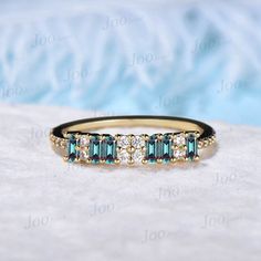 a gold ring with blue and white stones