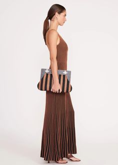 The Alba Frame Clutch is an oversized soft clutch with a structured wooden frame and turnlock closures. This style features an interior zipper pocket and a removable mirror. Details: 72% Polyester, 28% Viscose Striped raffia clutch with wooden frame 14.8" W x 9.13" H x 2.6" D Chic Staud Shoulder Bag With Leather Handles, Chic Brown Evening Bag With Detachable Handle, Chic Staud Shoulder Bag For Travel, Chic Brown Evening Bag, Chic Staud Shoulder Bag, Chic Brown Staud Bags, Structured Brown Shoulder Bag For Evening, Chic Brown Clutch For Evening, Elegant Brown Staud Shoulder Bag