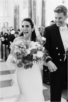 a bride and groom are walking down the aisle at their wedding in black and white