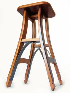 a wooden stool sitting on top of a white floor