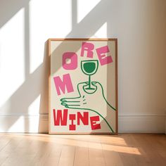 a framed poster with the words more mom wine on it in front of a white wall