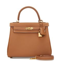 This Retourne Kelly is of gold togo leather with gold hardware and has contrast stitching, front flap, two straps with center toggle closure, clochette with lock and two keys, single rolled handle and an optional shoulder strap.The interior is lined with gold chevre leather and has one zip pocket with an Hermes engraved pull and one open pocket on the opposite side.Collection: ZOrigin: FranceCondition: Pristine; new or never (plastic on hardware)Accompanied by: Hermes box, Hermes dustbag, clochette, lock, two keys, shoulder strap, carebook, shoulder strap dustbag, felt, rainhat, ribbon and carebookMeasurements: 9.8" width x 7.5" height x 3.5" depth; 3.5" handle drop (16.5" shoulder strap drop) Hermes Kelly Retourne, Hermes Style, Dream Bags, Hermes Box, Togo Leather, Hermes Bags, Leather Care, Gold Leather, Gold Hardware