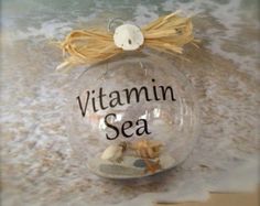 a glass ornament with the words vitamin sea in it