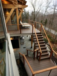 an outdoor deck with stairs leading up to the upper level