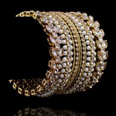 A must-have set of bangles for your year-round festive wardrobe! A versatile bangles set laced with champagne stones and pearl beads. One order includes two bangle sets for two hands. Available in various sizes. Antique gold-plated on high-quality brass as base metal. Size 2.4 & 2.8 is in-stock & ready-to-ship. Delivery time frame for Size 2.6 is 4-6 weeks. For custom or urgent requests, please contact support@alacouture.com. *Please Note: We use faux stones and beads in all of our jewelry. Gold Beaded Bangle For Wedding, Elegant Openable Bangle For Celebration, Elegant Gold Pearl Bracelet, Elegant Gold Pearl Bracelet For Festive Occasions, Elegant Openable Bangle For Festive Occasions, Elegant Festive Openable Bangle, Festive Elegant Openable Bangle, Elegant Jeweled Bangle For Celebrations, Elegant Jeweled Bracelets For Celebration